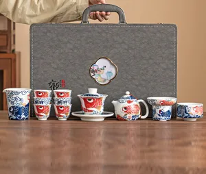 Traditional Chinese ceramic kung fu tea set with koi fish design, elegant gift box.
