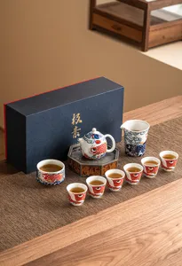 Detailed view of the ceramic tea set showing exquisite koi fish patterns, teapot, and cups.