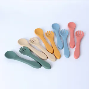 Silicone baby spoon and fork set, soft infant feeding utensils for self-feeding toddler use.