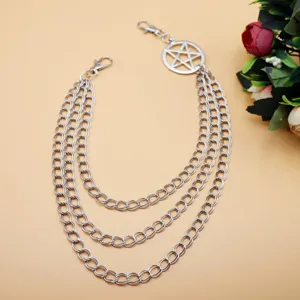 Detail view of a punk style multi-layer metal pants chain with a pentagram pendant and clasps.