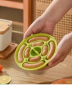 Silicone sausage mold for baby food DIY, green round steamer plate for homemade snacks.