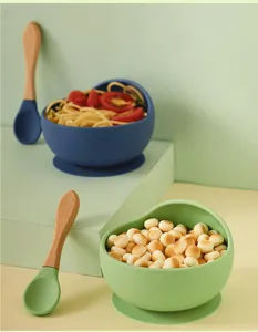 Silicone baby suction bowl and wooden handle spoon set detail view for infant feeding training.
