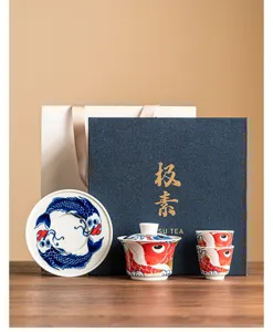 Ceramic kung fu tea set with koi fish pattern, includes gaiwan and cups in gift box.