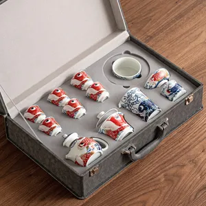 Ceramic Kung Fu tea set in gift box featuring traditional red and blue carp fish design.