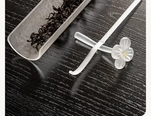 Frosted glass plum blossom tea needle and pillow set detail, elegant oriental tea ceremony accessory.