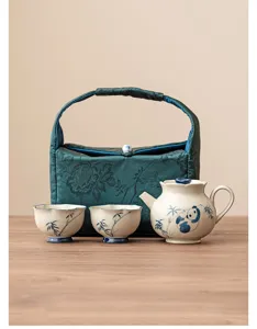 Portable ceramic tea set with cute panda and bamboo design, includes teapot, cups and bag.