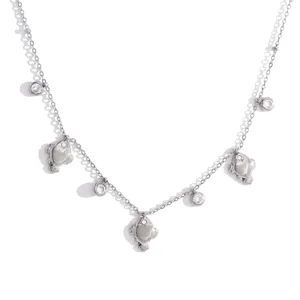 Detail view of the silver-tone necklace featuring multiple sparkling charms and bear pendants.