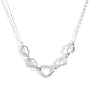 Detailed shot of double chain heart necklace with crystal pendant, silver finish jewelry.