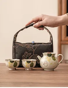 Hand-painted rabbit ceramic kung fu tea set with teapot, cups, and fabric storage bag.