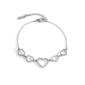 Detailed view of silver stainless steel heart bracelet featuring cubic zirconia and hollow charms.