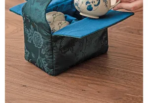 Detailed shot of the portable Chinese kung fu tea set with a green brocade storage bag.