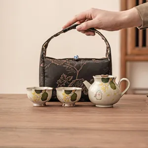 Hand-painted ceramic tea set with rabbit pattern, teapot, cups and storage bag.