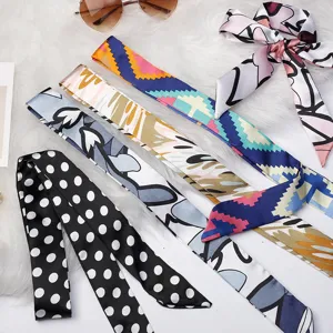 Assorted narrow silk scarves twillys for handbags and hair styling with colorful prints.