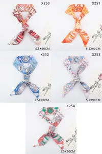 Detailed view of luxury style printed silk twilly scarf for handbag handle decoration.