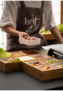 Close-up of bamboo grid tray in use, ideal for hot pot and barbecue side dishes display.