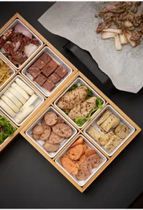 Bamboo nine-grid serving tray detail shot, perfect for hot pot and BBQ side dishes setup.