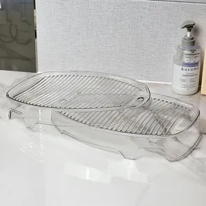 Close-up detail of compact transparent plastic washboard for small laundry and socks washing.