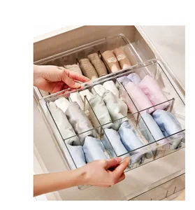 Clear plastic drawer organizer detail showing partitioned compartments for socks and underwear storage.