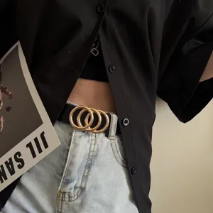 Detail shot of a women's vintage decorative belt with double ring buckle styling.