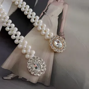 Pearl waist belt with rhinestone buckle, elegant vintage elastic dress accessory for women.