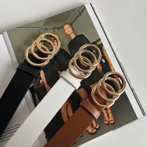 Detail view of stylish women double ring buckle belts in black white and brown colors.