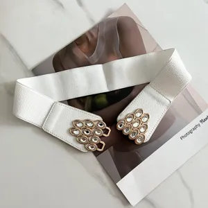 Detail view of white elastic waist belt with sparkling rhinestone decorative buckle.