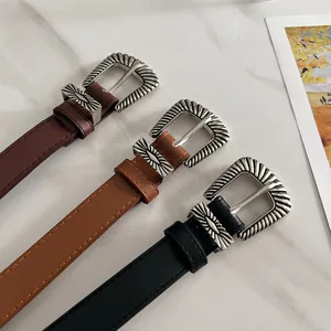 Vintage brown wide belt featuring ornate silver buckle, perfect y2k western fashion detail.