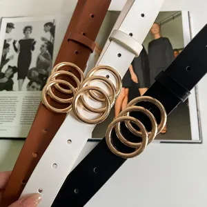 Detail view of women's fashion PU leather belt featuring chic gold double ring metal buckle.