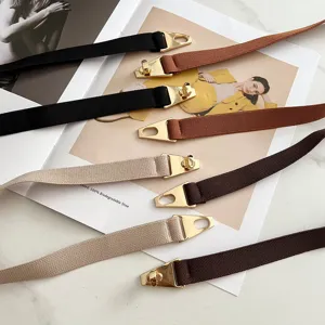 Detailed view of women stretch waist belt with golden metal buckle, versatile elastic accessory.