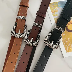 Close-up detail view of American vintage western style wide leather belts in three colors.