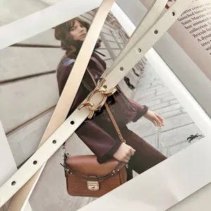 Cintura da donna sottile in ecopelle alla moda con fibbia a catena dorata, accessorio chic.