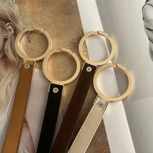 Thin decorative leather belt with large round metal ring, perfect for dresses and suits.