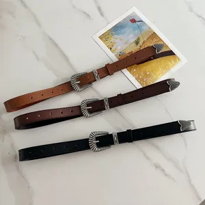 Detailed view of three western vintage PU leather belts in black, brown and tan colors.