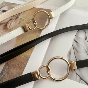 Close-up detail of adjustable thin women belt with stylish interlocking metal ring buckles.