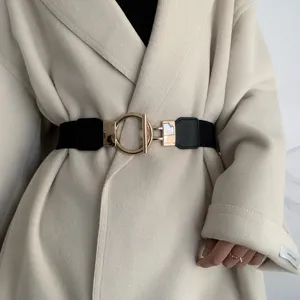 Wide elastic waist belt for women featuring a stylish gold metal ring buckle. Perfect for coats.