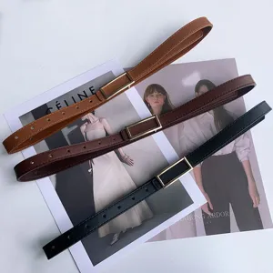 Detailed close-up view of minimalist women leather belts featuring sleek rectangular metal buckles.