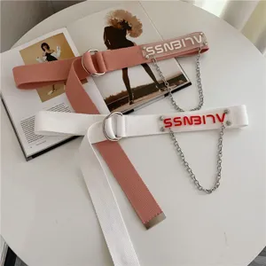 Canvas belt detail shot featuring dual metal rings and hanging chain design for women.