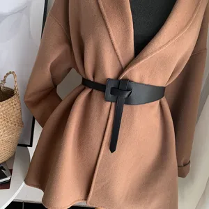 Black knot waist belt detail shot, stylish leather waist cincher for women's winter coats.