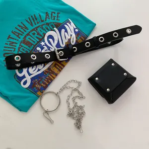 Detail view of punk style black leather grommet belt with small pouch and metal chain.