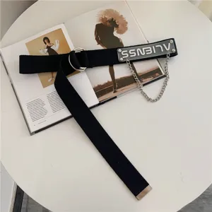 Detailed shot of trendy black canvas belt with metal double ring buckle, chain and acrylic tag.