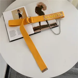 Yellow canvas belt for women with metal double ring buckle, chain, and transparent tag.