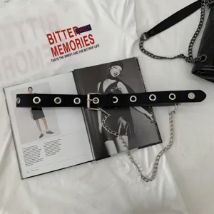 Women's punk style black leather belt with metal eyelets and decorative chain accessory.