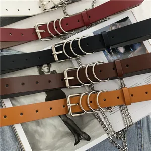Close-up of vintage punk style women leather belts featuring double O-rings and metal chains.