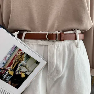 Vintage brown leather belt for women, slim adjustable waist strap with metal buckle.