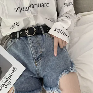 Women stylish denim shorts and metal ring belt detail shot, trendy casual summer clothing.