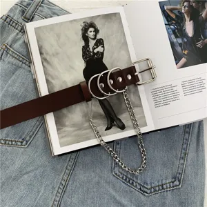 Punk style brown leather belt with metal O-rings and chain accessory for women detail.