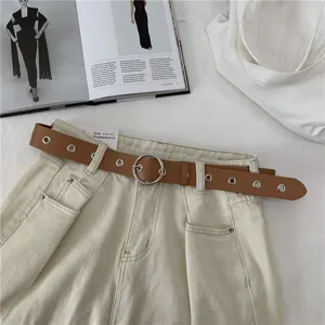 Brown women belt with metal ring buckle and eyelets, casual fashion accessory for jeans.