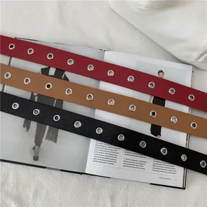 Detail shot of stylish women leather belt with metallic eyelets, casual fashion accessory.