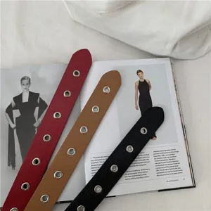 Women's fashion metal eyelet PU leather belt detail, casual daily trousers waistband accessory.