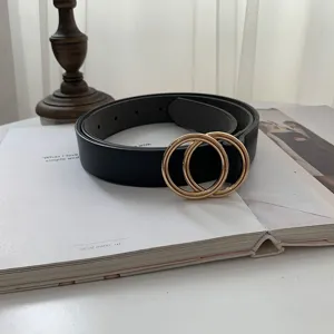 Vintage black leather belt with gold double ring buckle, versatile jeans accessory.